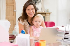 Mother and baby in home office with laptop work at home with child